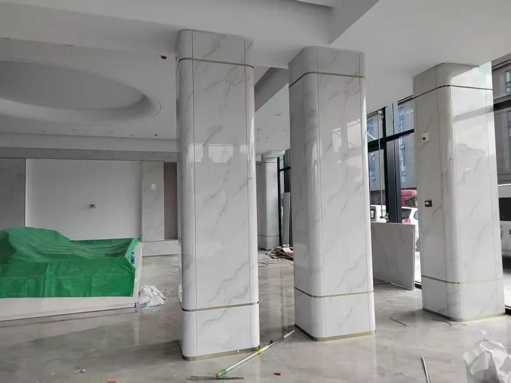 Sintered stone column cladding — installation in progress